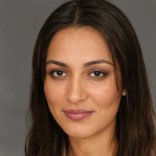 Joyful white young-adult female with long  brown hair and brown eyes