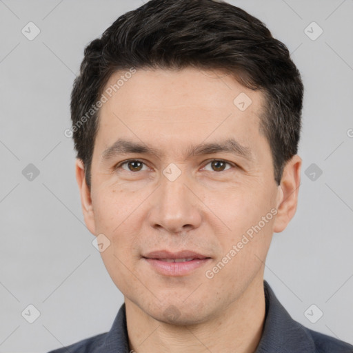 Joyful white adult male with short  black hair and brown eyes