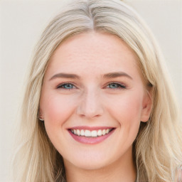 Joyful white young-adult female with long  brown hair and blue eyes