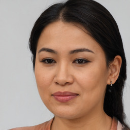 Joyful asian young-adult female with medium  brown hair and brown eyes