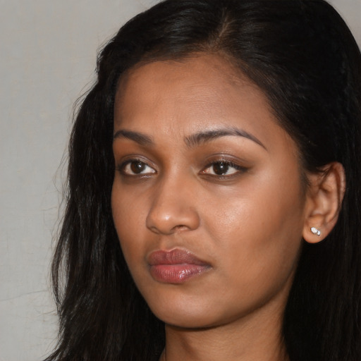 Neutral black young-adult female with long  brown hair and brown eyes