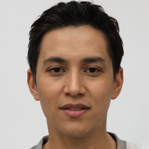 Joyful asian young-adult male with short  black hair and brown eyes