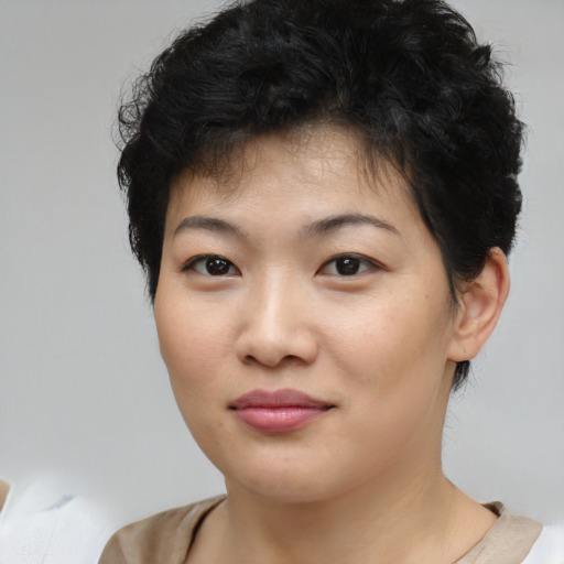 Joyful asian young-adult female with short  brown hair and brown eyes