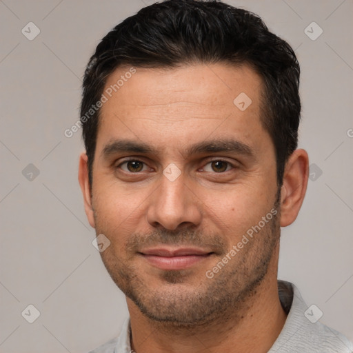 Joyful white young-adult male with short  black hair and brown eyes