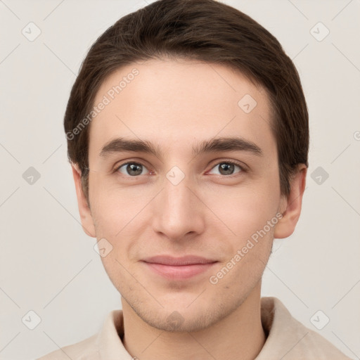 Joyful white young-adult male with short  brown hair and grey eyes