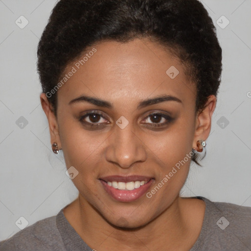 Joyful black young-adult female with short  brown hair and brown eyes