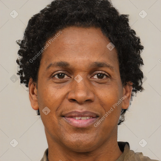 Joyful black adult male with short  brown hair and brown eyes