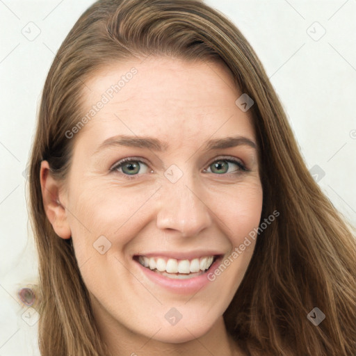 Joyful white young-adult female with long  brown hair and green eyes