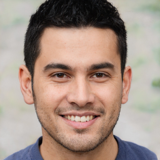 Joyful white young-adult male with short  black hair and brown eyes