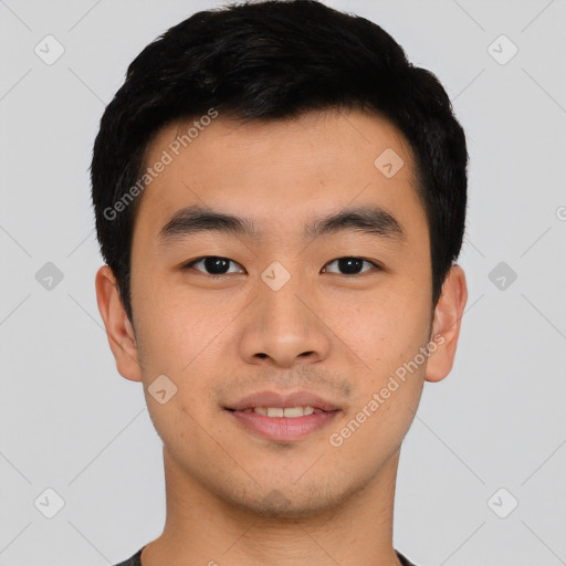 Joyful asian young-adult male with short  black hair and brown eyes