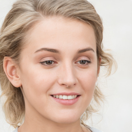 Joyful white young-adult female with long  brown hair and blue eyes