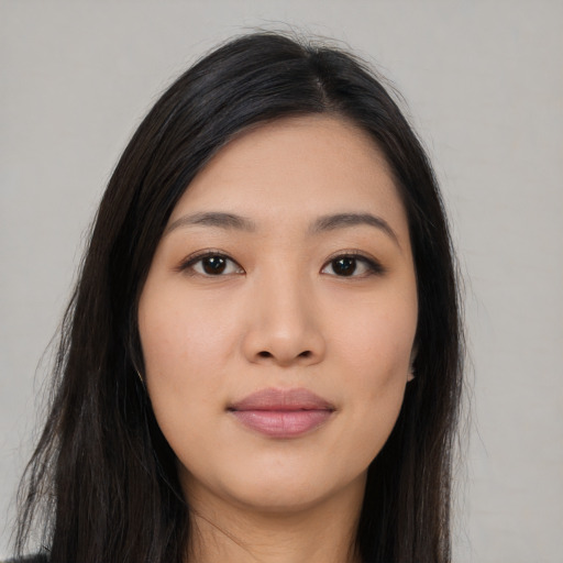 Joyful asian young-adult female with long  black hair and brown eyes