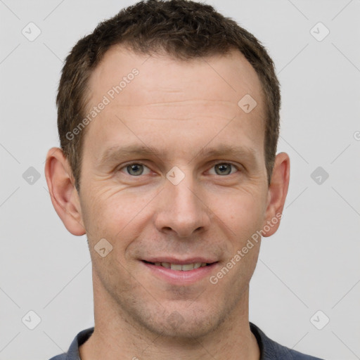 Joyful white adult male with short  brown hair and grey eyes