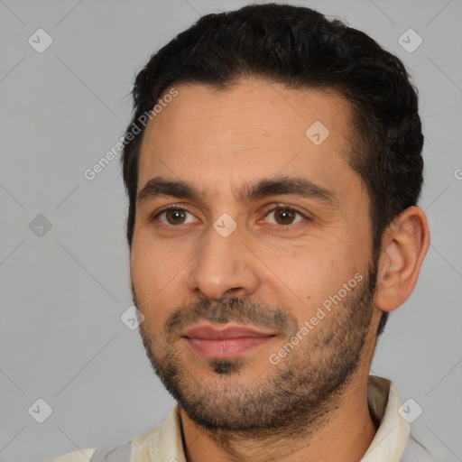 Joyful white young-adult male with short  black hair and brown eyes