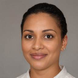 Joyful latino young-adult female with short  brown hair and brown eyes