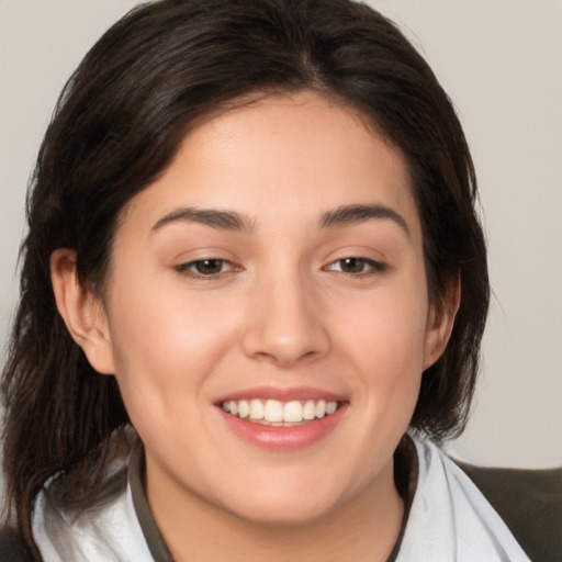 Joyful white young-adult female with medium  brown hair and brown eyes