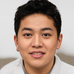 Joyful asian young-adult male with short  brown hair and brown eyes