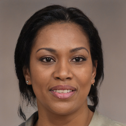 Joyful black adult female with medium  brown hair and brown eyes
