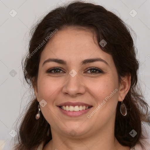 Joyful white adult female with long  brown hair and brown eyes