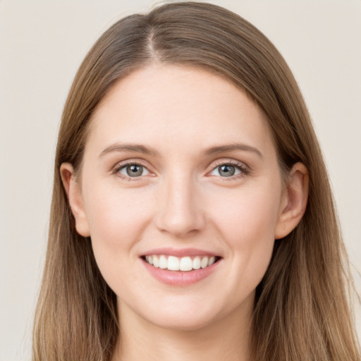 Joyful white young-adult female with long  brown hair and grey eyes