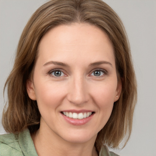 Joyful white young-adult female with medium  brown hair and grey eyes