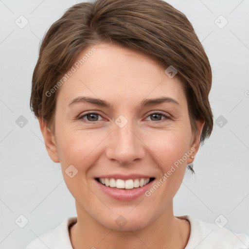 Joyful white young-adult female with short  brown hair and grey eyes