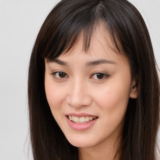 Joyful white young-adult female with long  brown hair and brown eyes