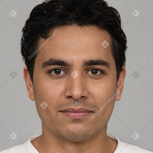 Joyful white young-adult male with short  black hair and brown eyes