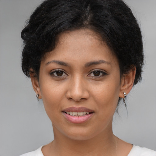 Joyful latino young-adult female with short  brown hair and brown eyes