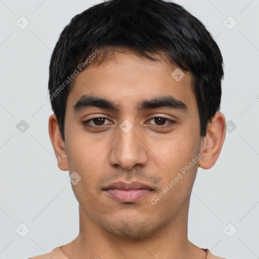 Neutral latino young-adult male with short  black hair and brown eyes