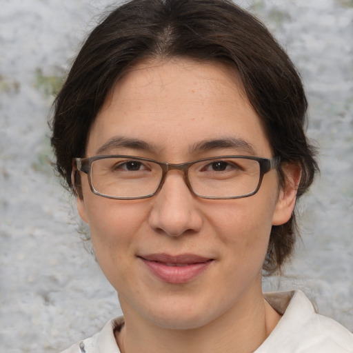 Joyful white adult female with medium  brown hair and brown eyes