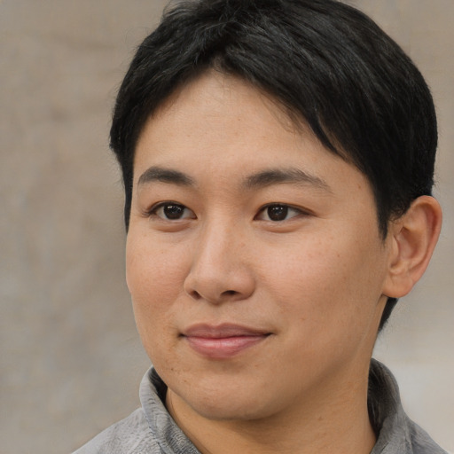 Joyful asian young-adult female with short  black hair and brown eyes