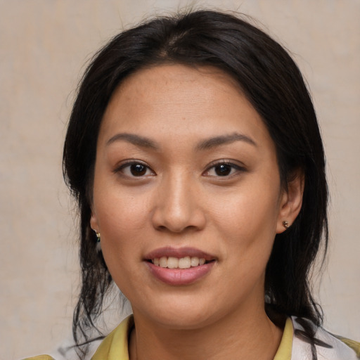 Joyful asian young-adult female with medium  black hair and brown eyes