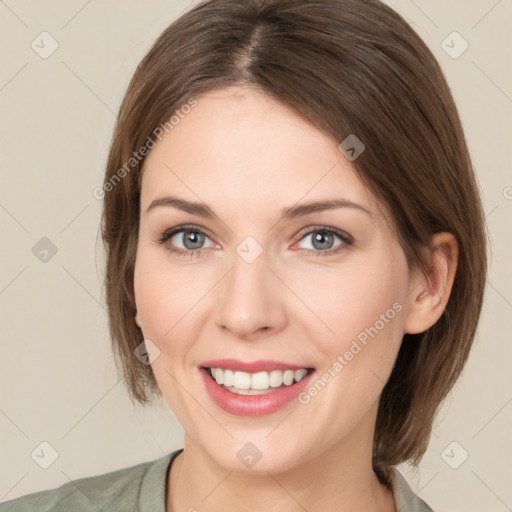 Joyful white young-adult female with medium  brown hair and grey eyes