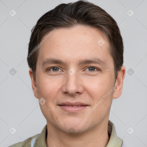 Joyful white young-adult male with short  brown hair and grey eyes