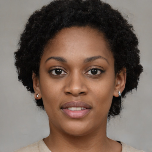 Joyful black young-adult female with short  black hair and brown eyes
