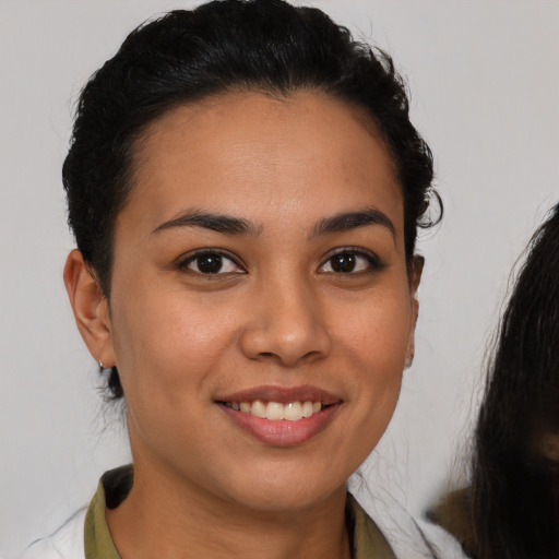 Joyful latino young-adult female with short  brown hair and brown eyes