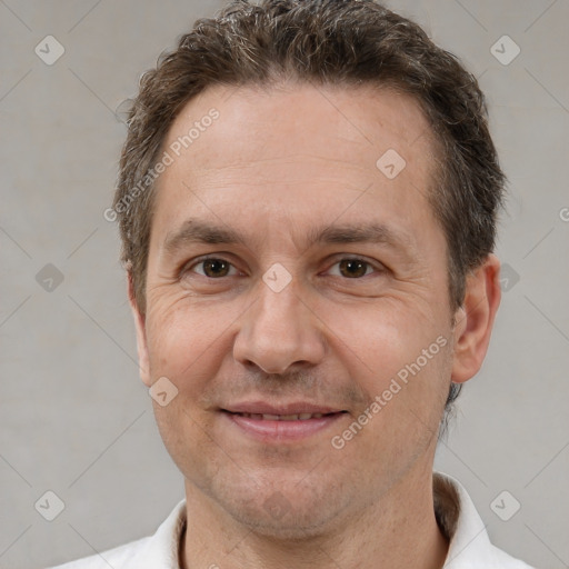 Joyful white adult male with short  brown hair and brown eyes