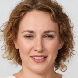 Joyful white young-adult female with medium  brown hair and green eyes