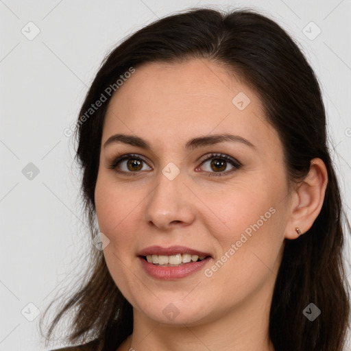 Joyful white young-adult female with long  brown hair and brown eyes