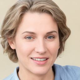 Joyful white young-adult female with medium  brown hair and blue eyes