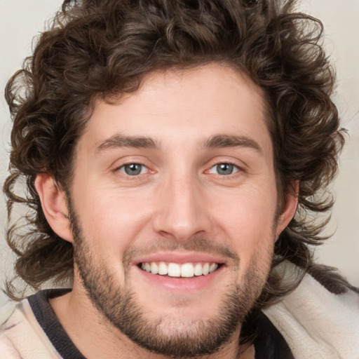 Joyful white young-adult male with medium  brown hair and brown eyes