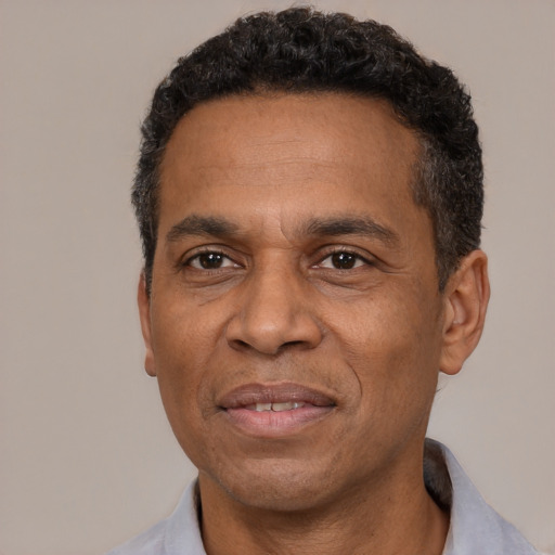 Joyful latino adult male with short  black hair and brown eyes