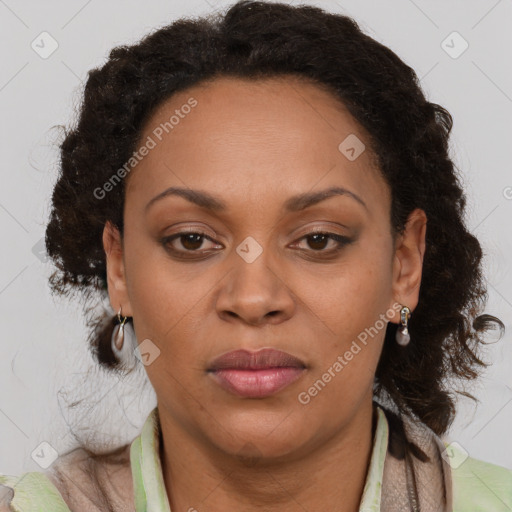 Joyful black adult female with medium  brown hair and brown eyes