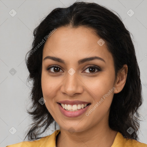 Joyful latino young-adult female with long  brown hair and brown eyes