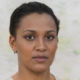 Joyful latino young-adult female with short  brown hair and brown eyes