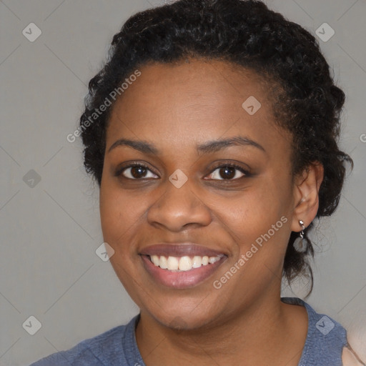 Joyful black young-adult female with medium  black hair and brown eyes