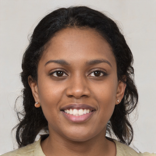 Joyful black young-adult female with medium  brown hair and brown eyes