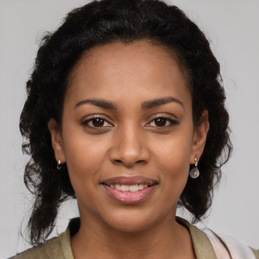 Joyful black young-adult female with medium  brown hair and brown eyes