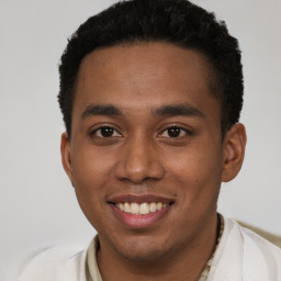 Joyful black young-adult male with short  brown hair and brown eyes